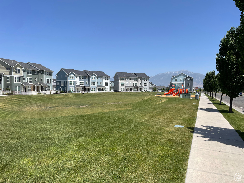 Surrounding community featuring a mountain view, a lawn, and a residential view