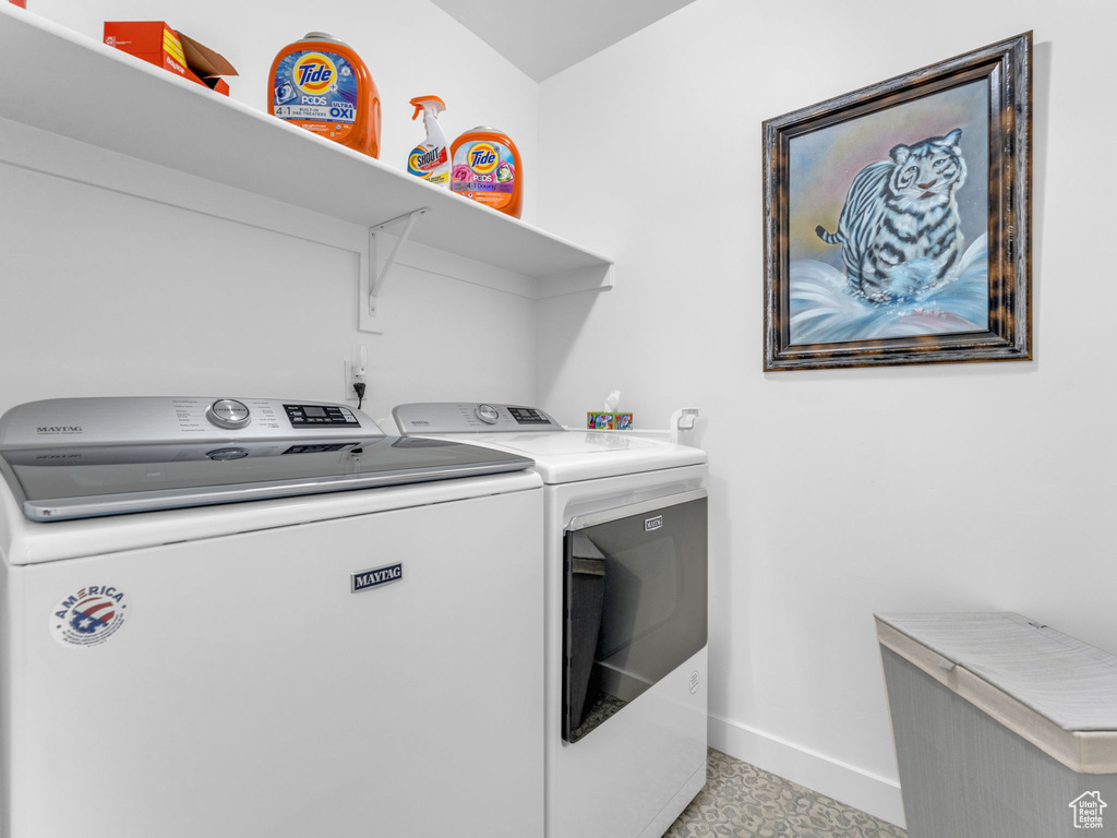 Laundry room with washer and dryer and baseboards