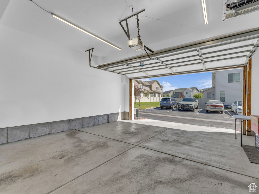Garage with a garage door opener and a residential view