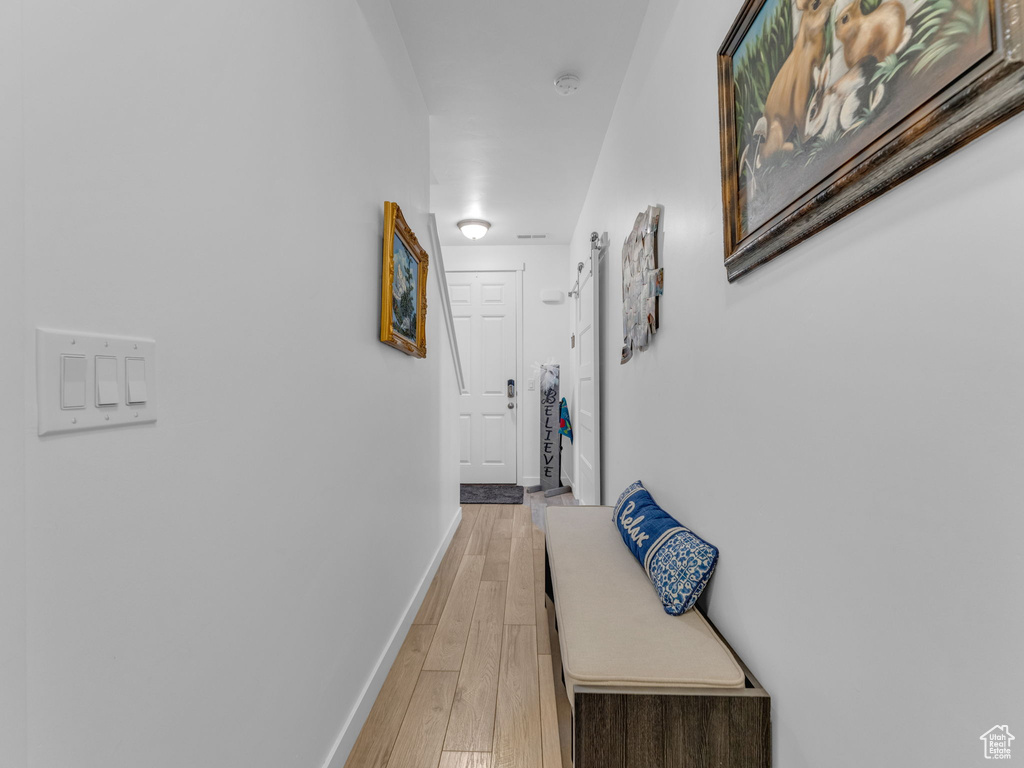 Corridor featuring baseboards and light wood-type flooring