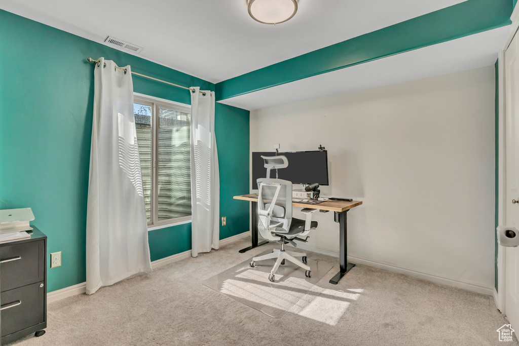 Home office featuring carpet and baseboards