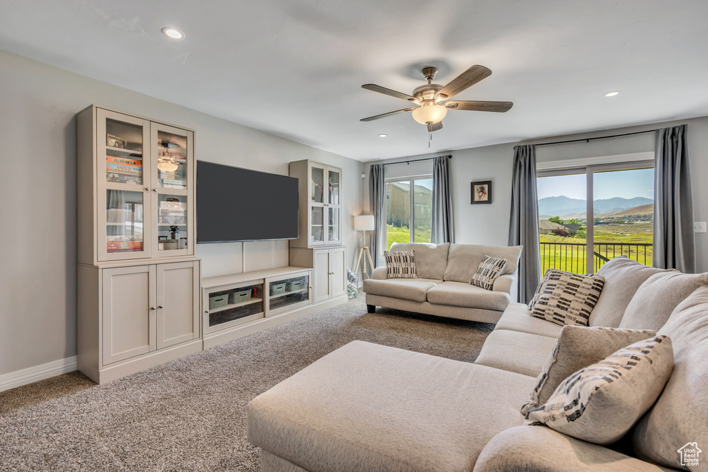 Carpeted living area featuring healthy amount of natural light, a ceiling fan, and recessed lighting