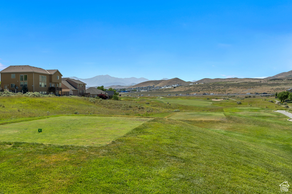View of grassy yard with a mountain view