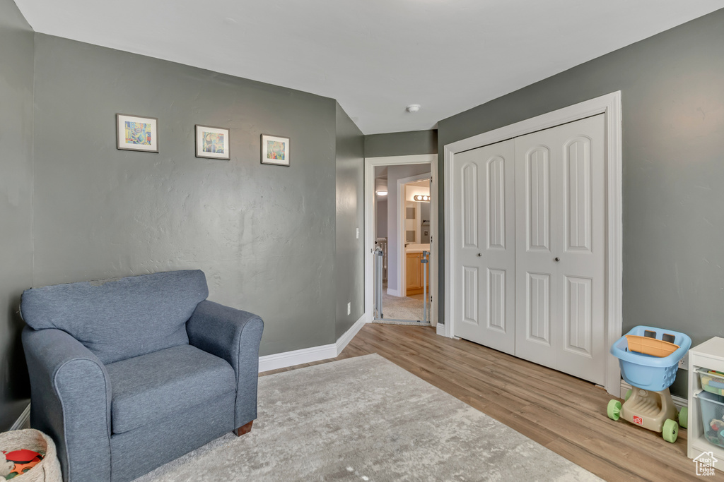 Sitting room with wood finished floors and baseboards