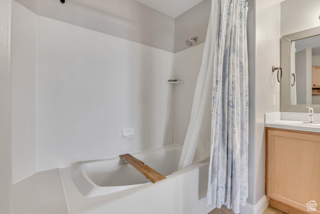Full bathroom featuring shower / bath combo with shower curtain and vanity