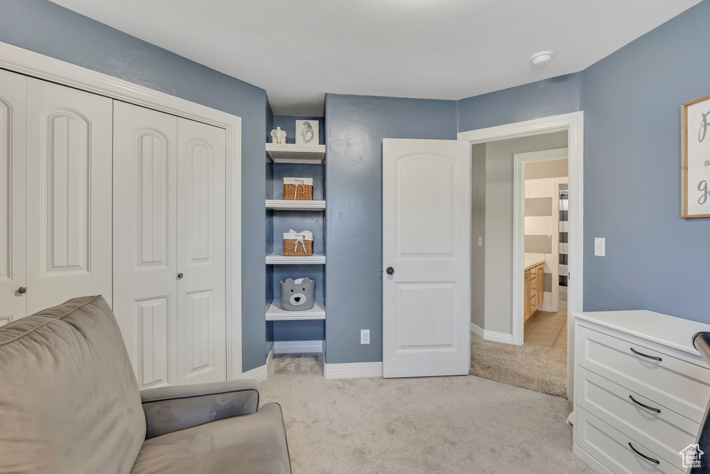 Sitting room with light carpet and baseboards