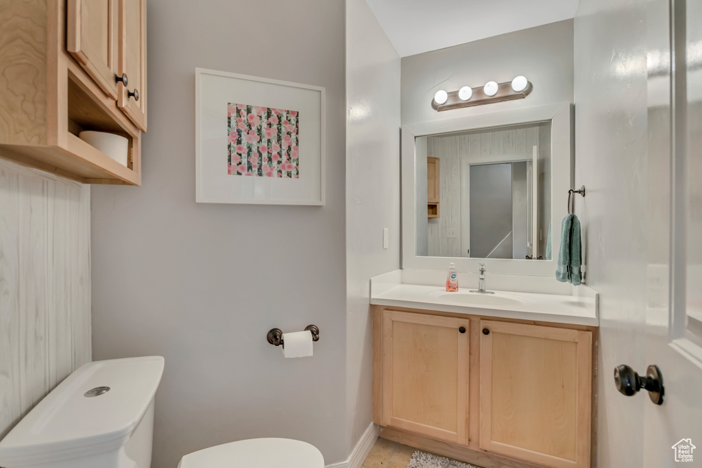 Half bathroom featuring toilet and vanity