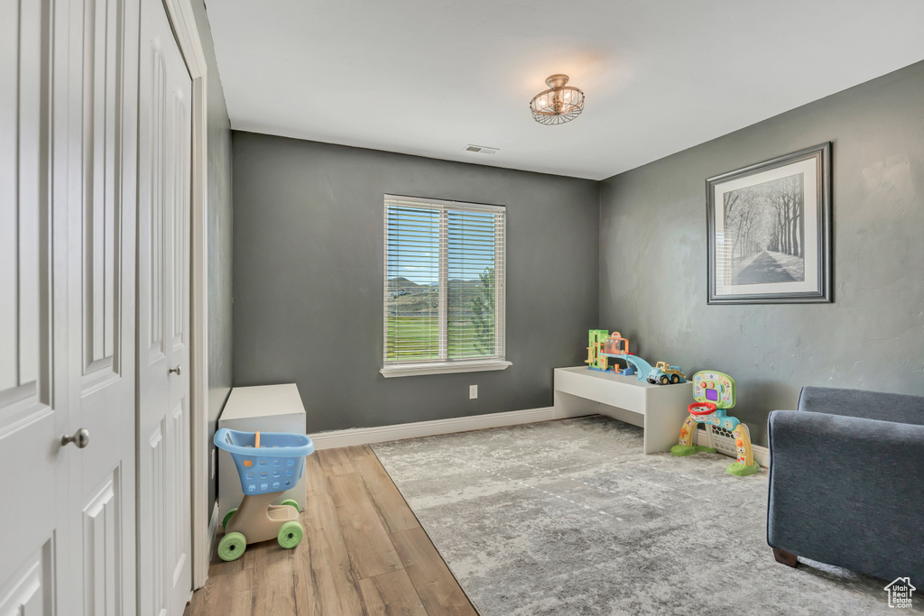 Recreation room featuring wood finished floors and baseboards