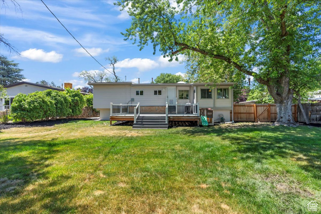 Back of property featuring a wooden deck