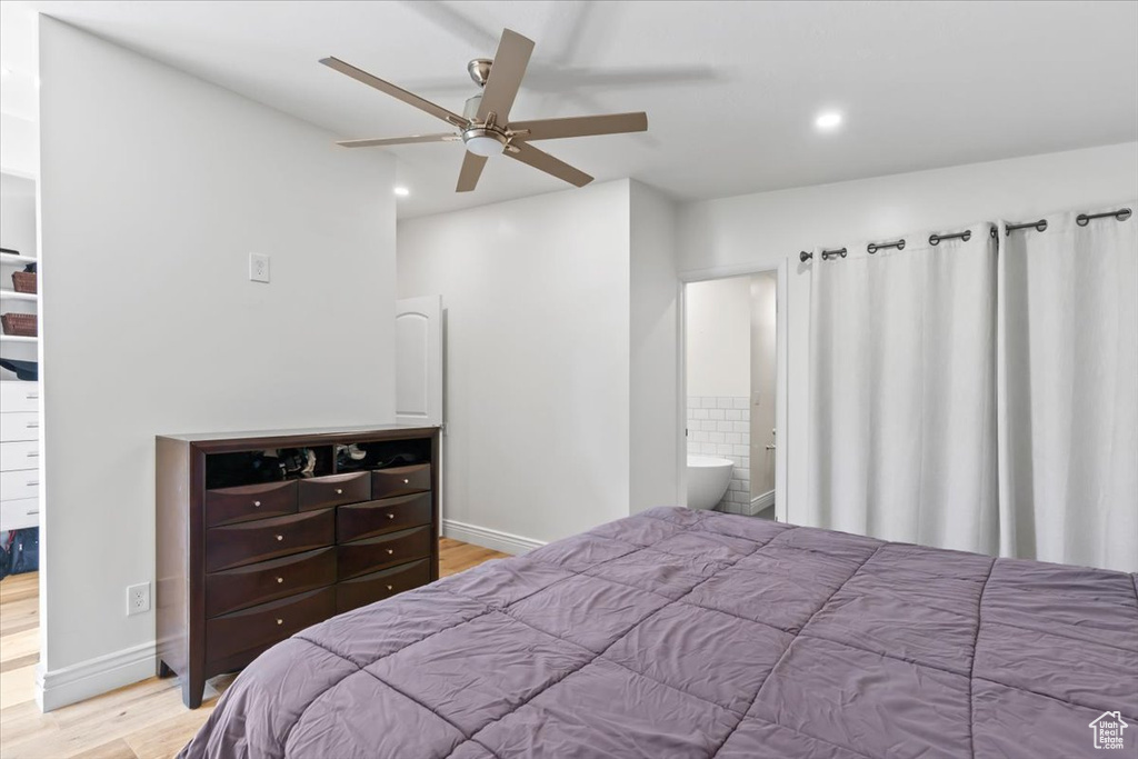 Bedroom with wood finished floors, recessed lighting, a ceiling fan, and ensuite bath