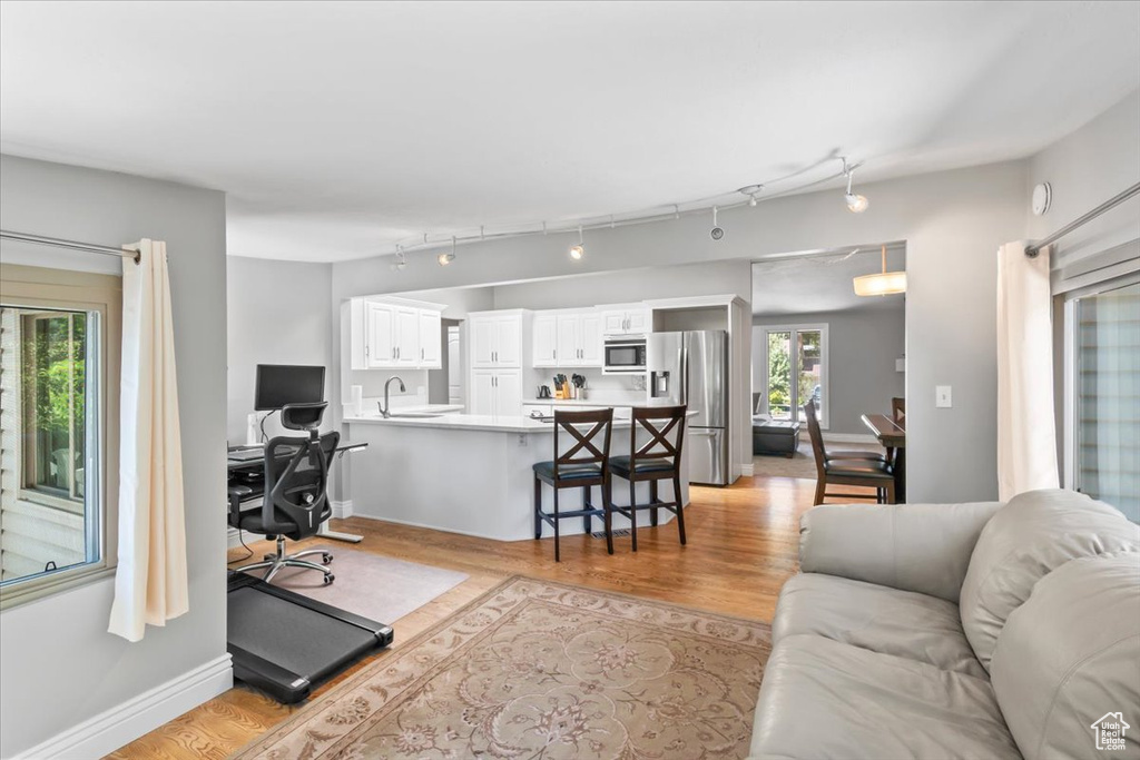 Living area featuring light wood-style flooring and a desk