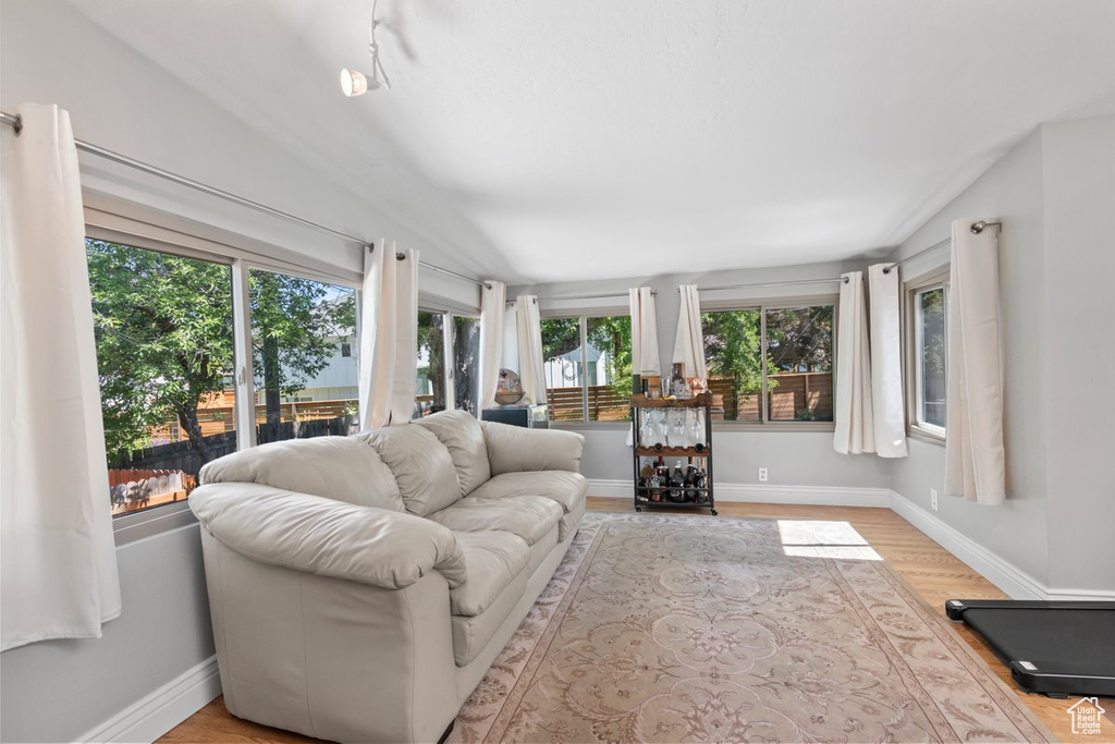 Sunroom with wood finished floors and baseboards