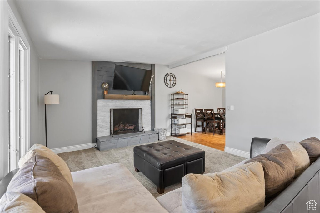 Living area with carpet floors and a fireplace