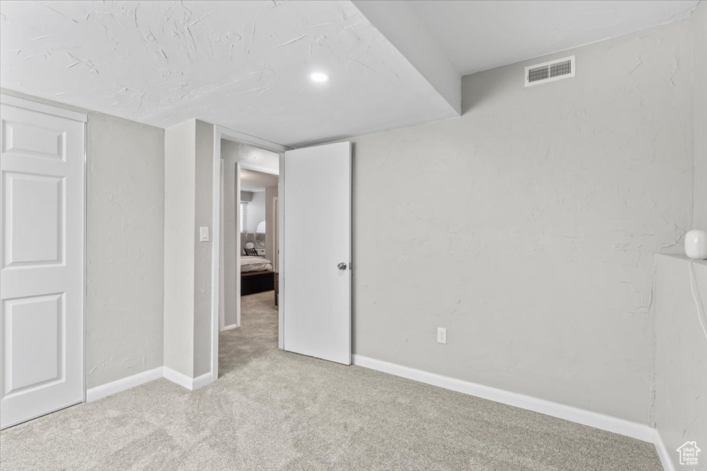 Unfurnished bedroom with carpet flooring and baseboards