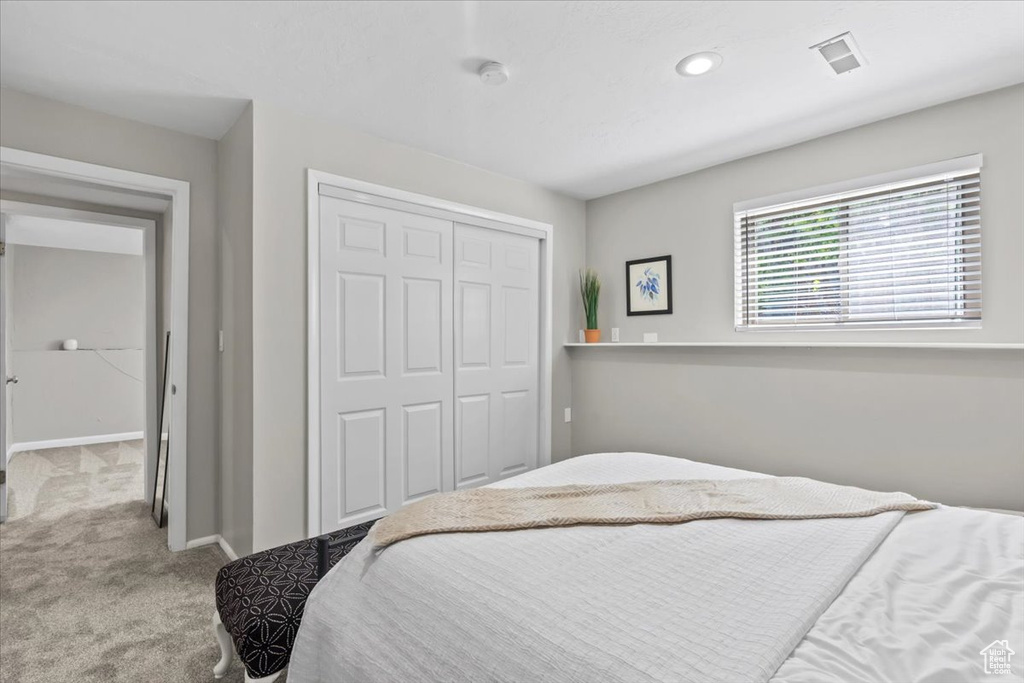 Bedroom featuring carpet floors, a closet, and recessed lighting