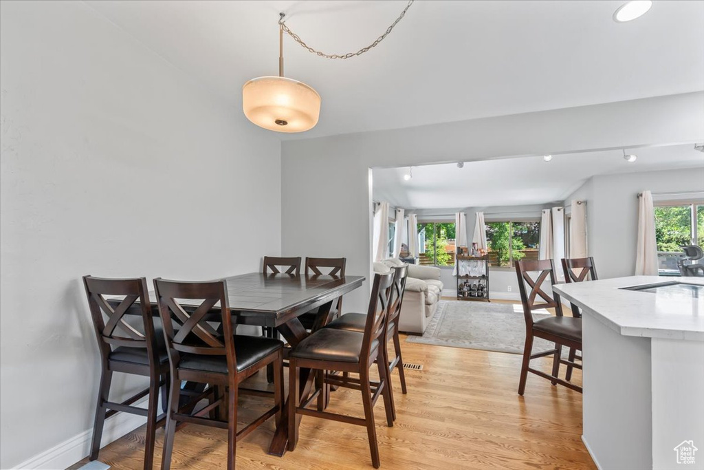 Dining space with light wood finished floors and baseboards