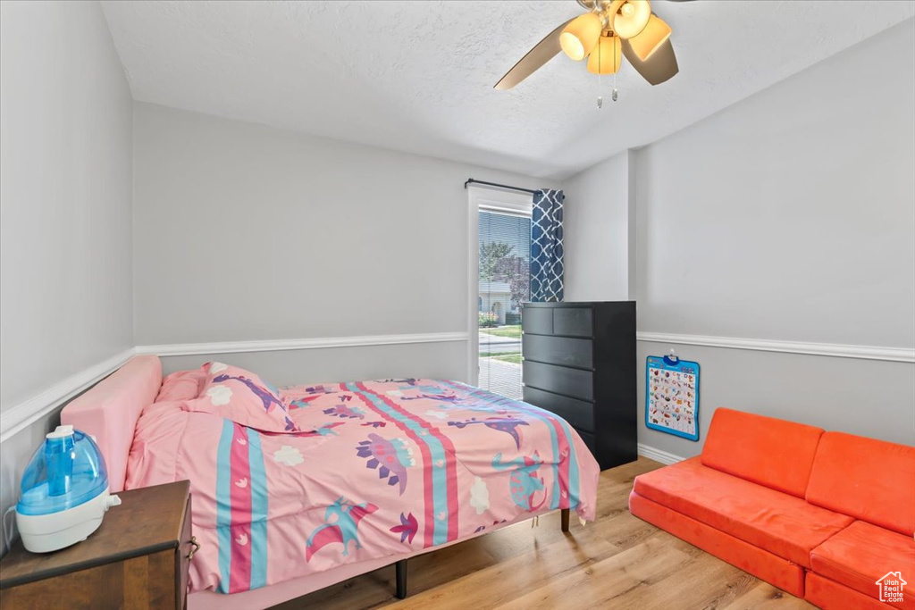 Bedroom featuring wood finished floors and a ceiling fan