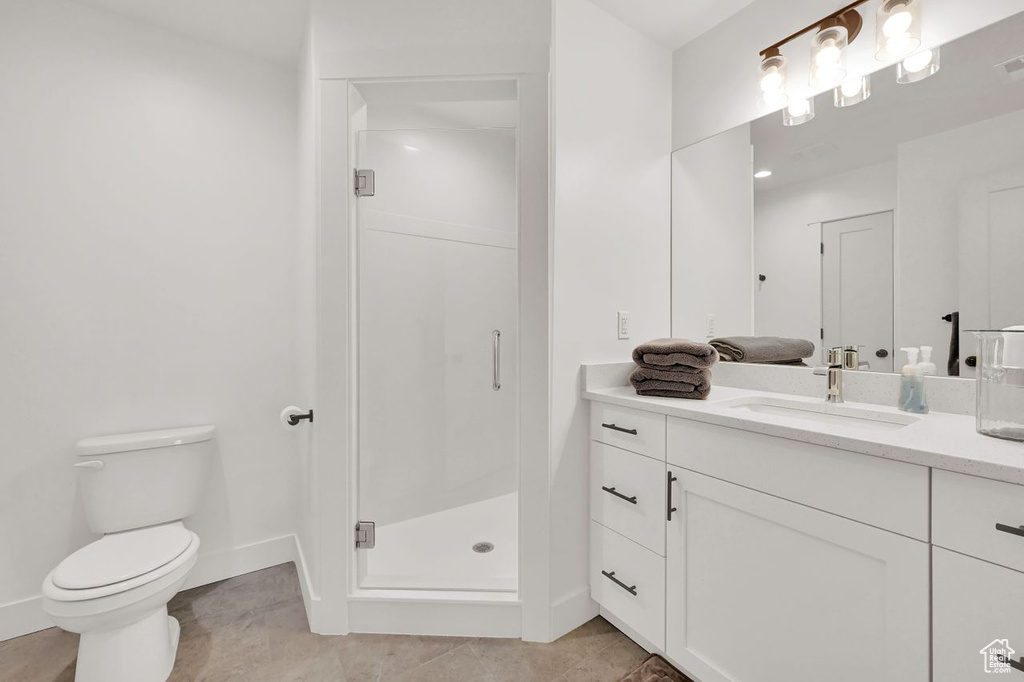 Bathroom featuring vanity and a stall shower