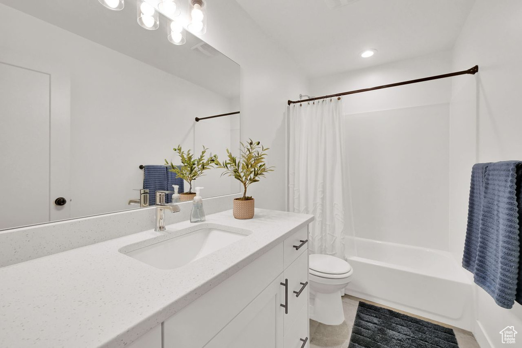 Full bathroom featuring vanity, shower / bath combo, and tile patterned flooring