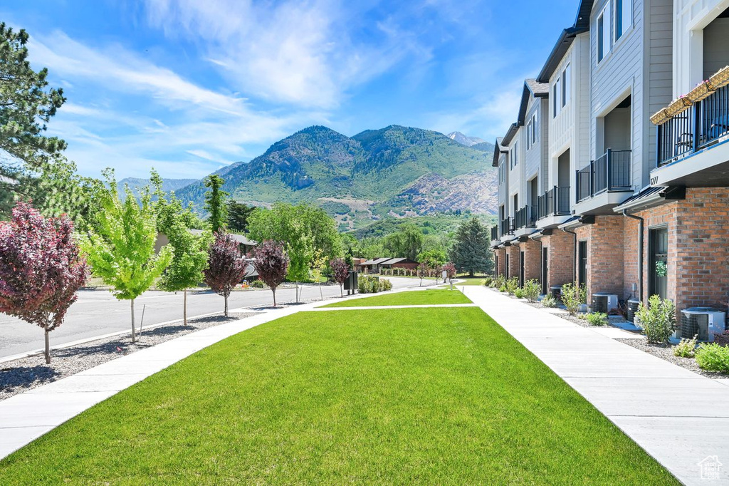 View of home\'s community with a mountain view and a lawn