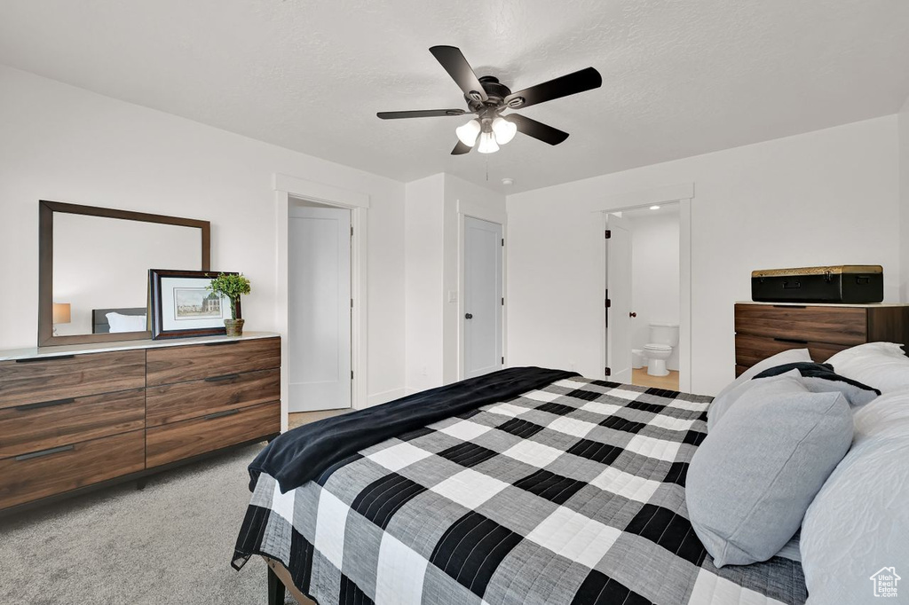 Bedroom with carpet flooring, ceiling fan, and ensuite bath