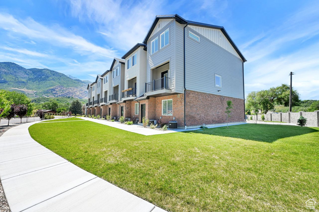 View of home\'s exterior featuring a lawn, brick siding, and a mountain view