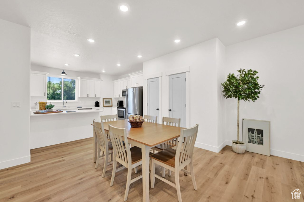 Dining room featuring light wood-style floors and recessed lighting