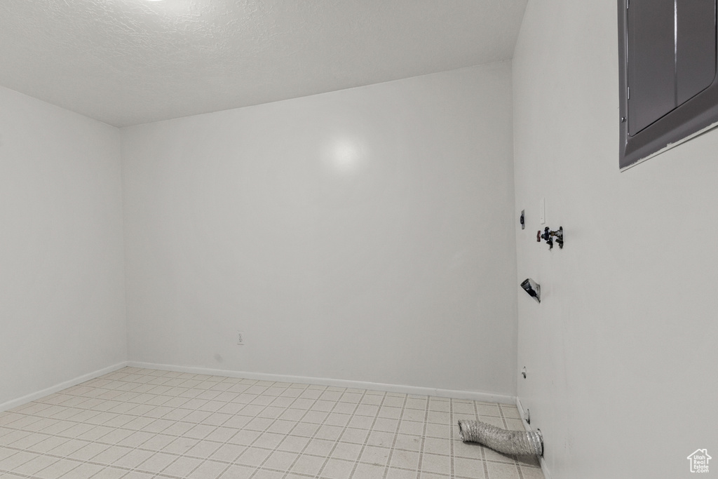 Unfurnished room featuring baseboards and light tile patterned floors