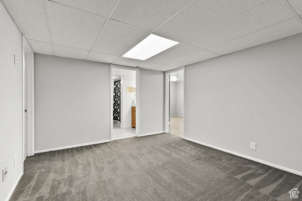 Finished below grade area featuring carpet flooring and a paneled ceiling