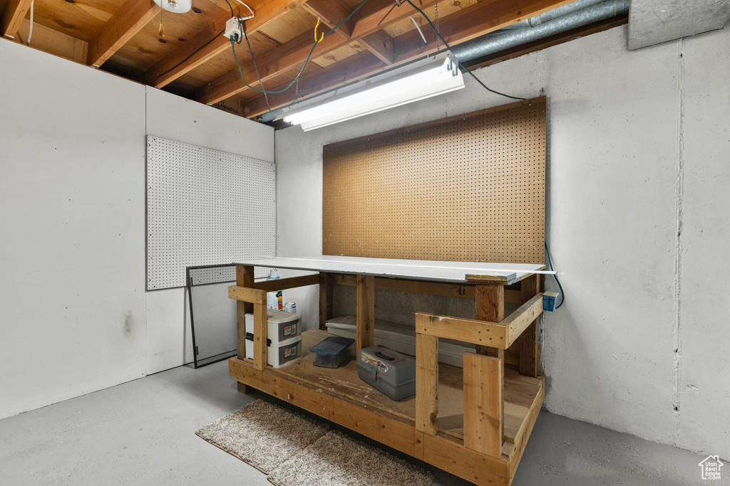 Unfinished basement featuring a workshop area