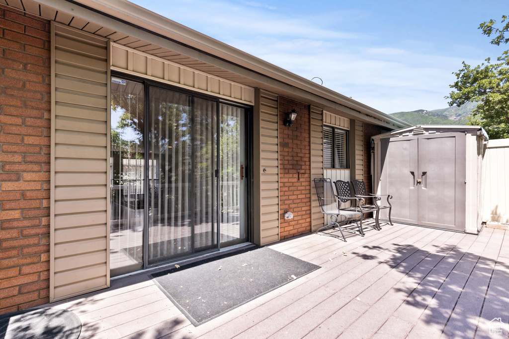 Deck featuring a storage shed