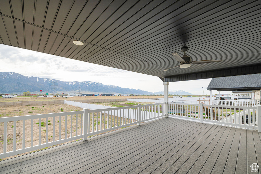 Wooden terrace featuring a mountain view and ceiling fan