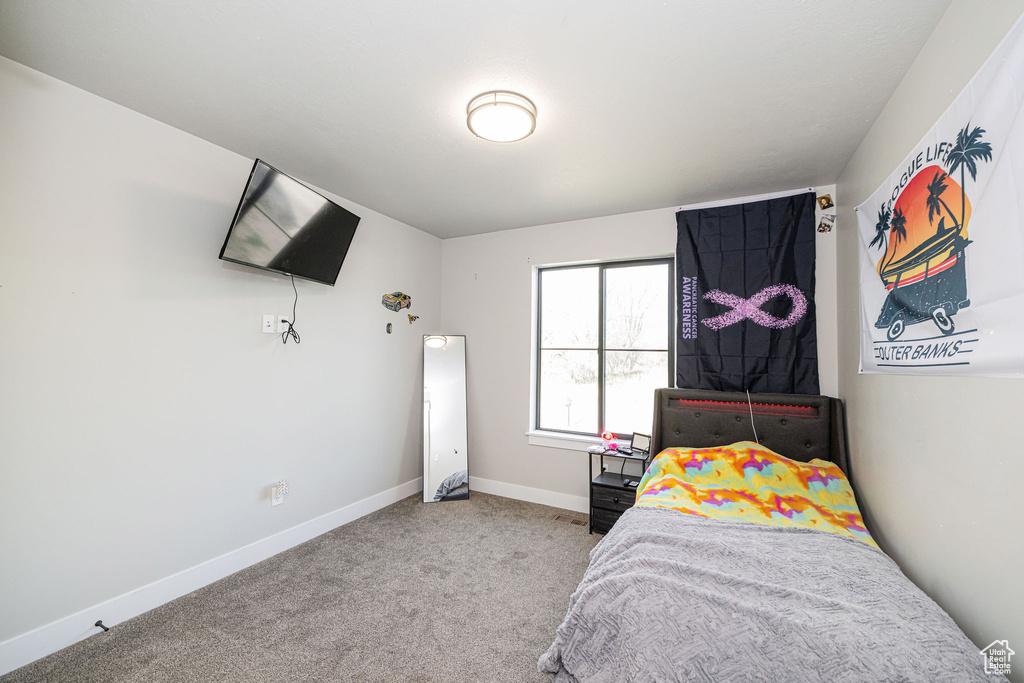 Carpeted bedroom featuring baseboards