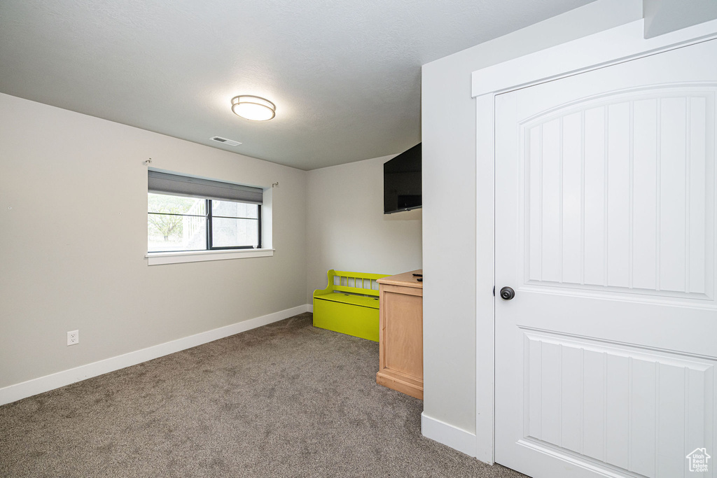 Unfurnished bedroom featuring carpet floors and baseboards