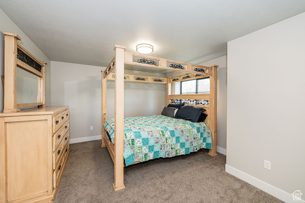 Bedroom with baseboards and carpet
