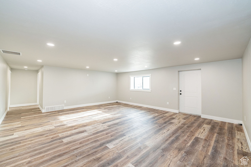 Basement with recessed lighting and light wood-type flooring