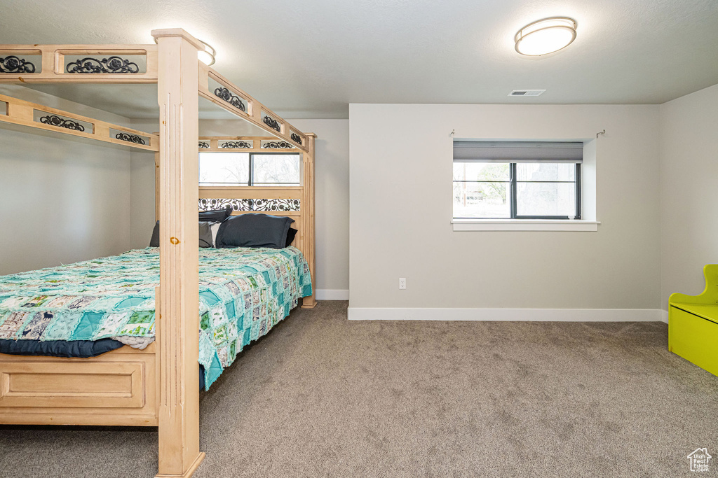 Carpeted bedroom with baseboards