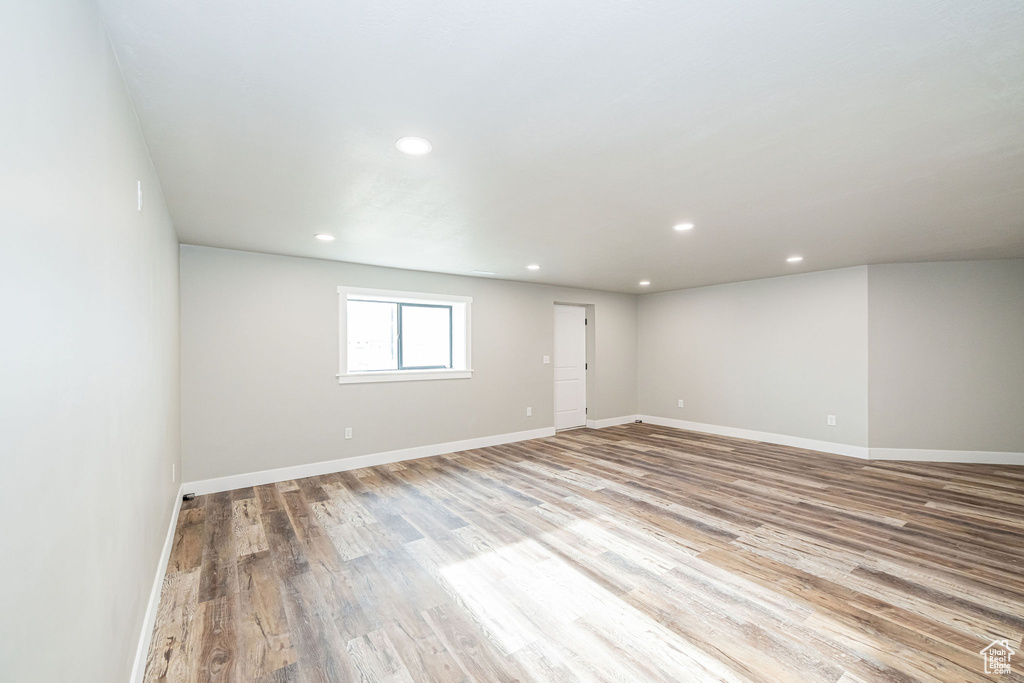 Unfurnished room with wood finished floors and recessed lighting
