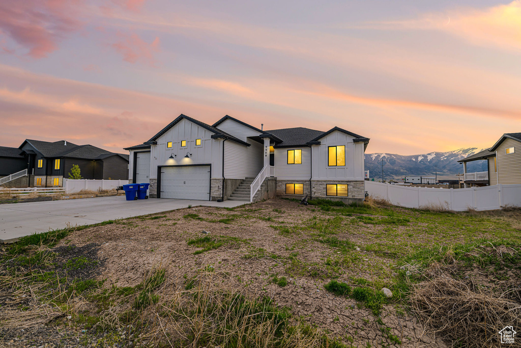 View of front of property featuring driveway, board and batten siding, and a garage