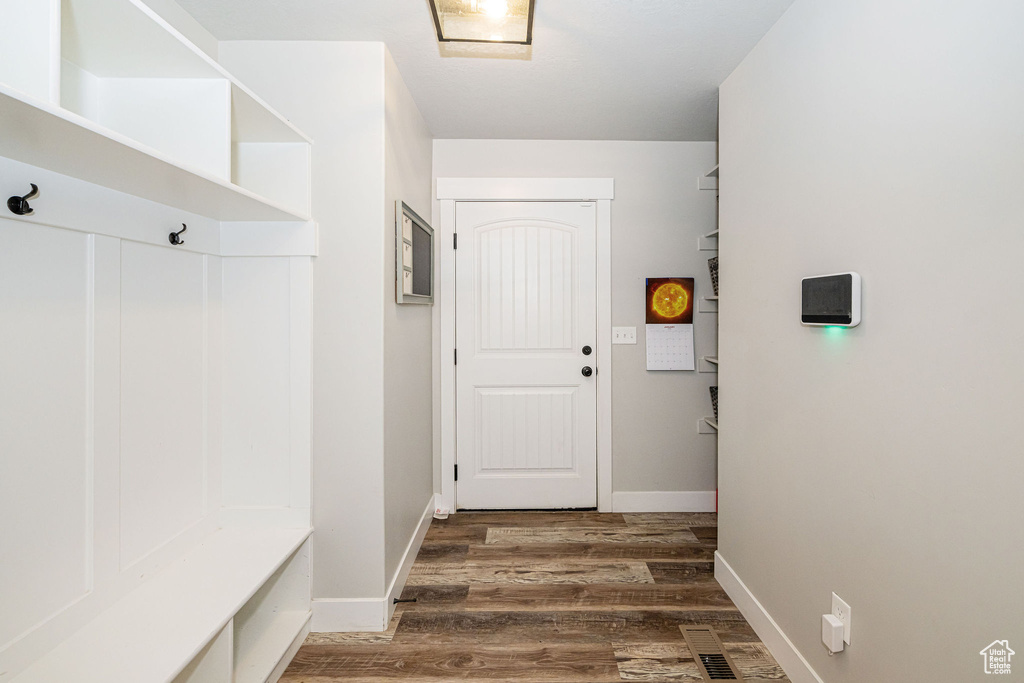 Mudroom with wood finished floors and baseboards