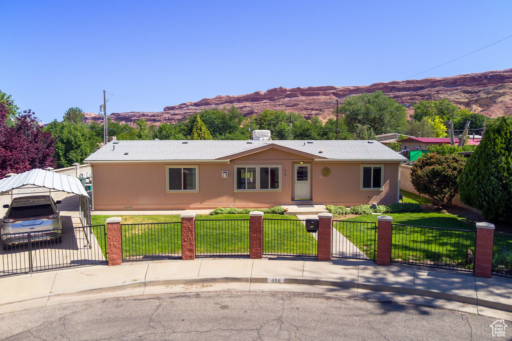Single story home with a fenced front yard, a mountain view, and a gate