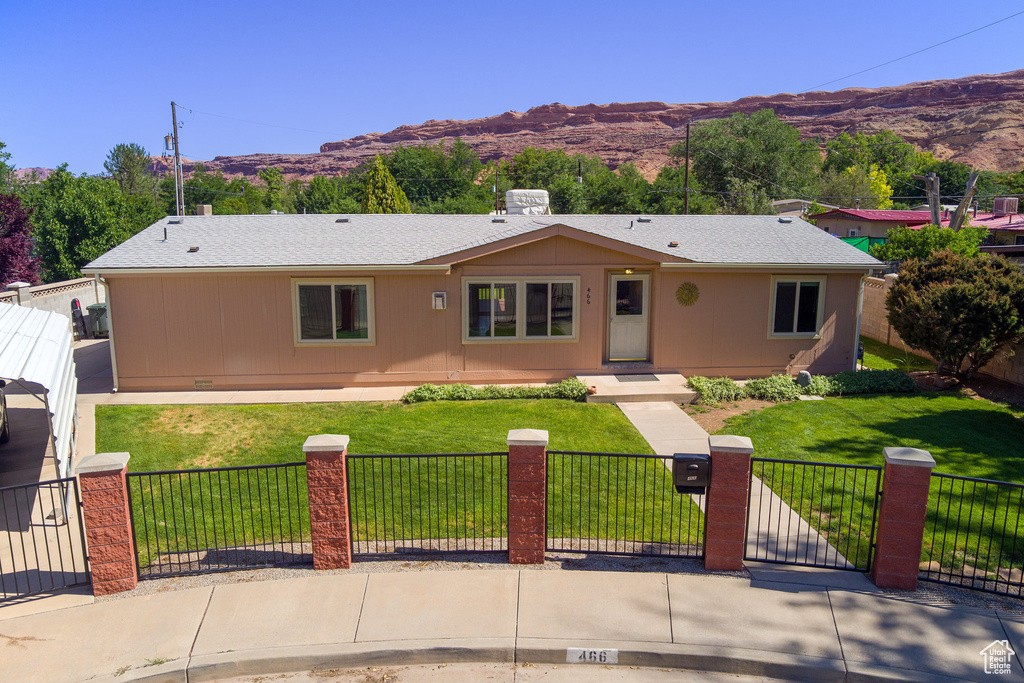 Single story home featuring a fenced front yard, a mountain view, and a gate