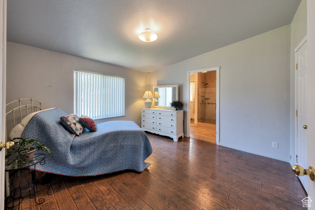 Bedroom with hardwood / wood-style floors and ensuite bathroom