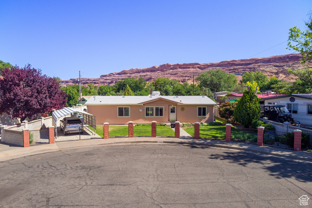 Ranch-style house with a mountain view, a fenced front yard, and a gate
