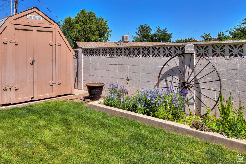 View of yard featuring a storage unit