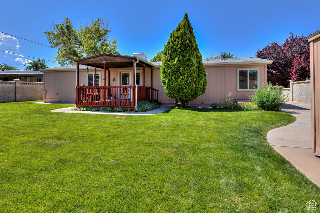 View of front of property with a wooden deck