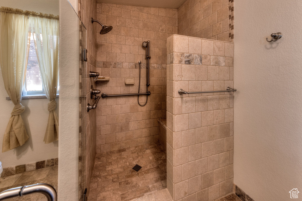 Full bath featuring tiled shower