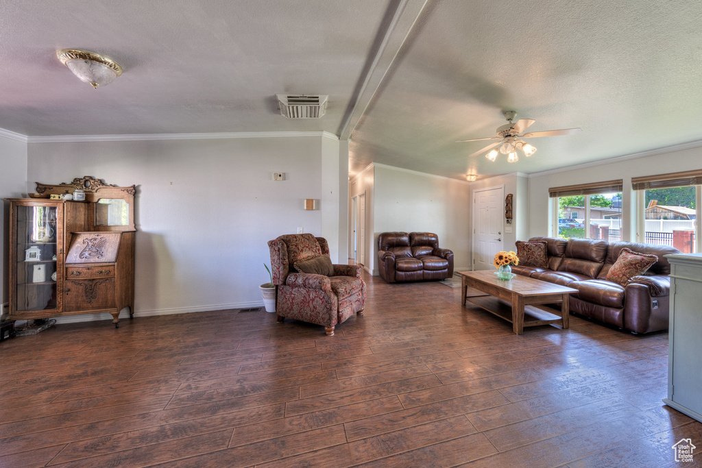 Living room with wood-type flooring, a ceiling fan, crown molding, and lofted ceiling