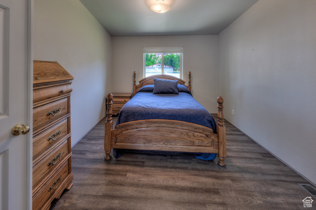 Bedroom with dark wood-style flooring
