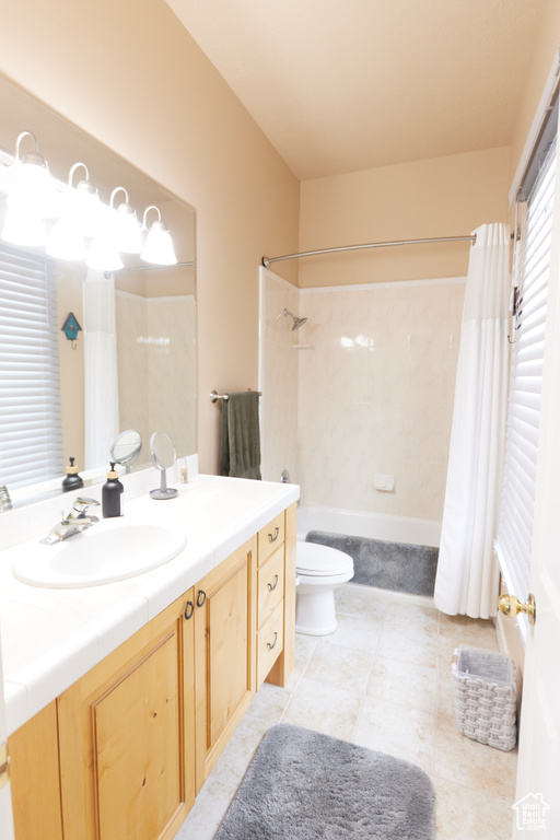 Bathroom featuring shower / tub combo with curtain and vanity